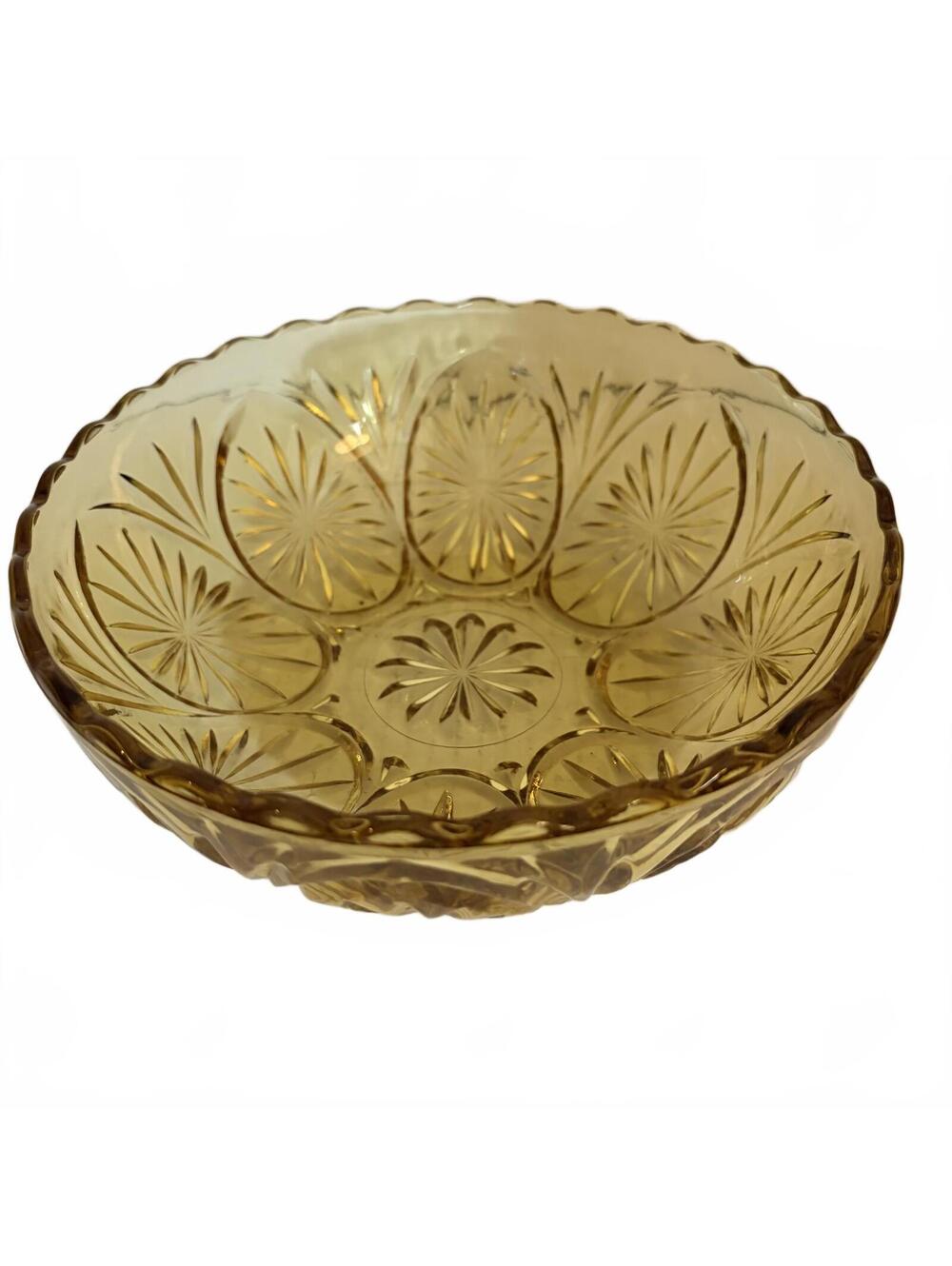 Amber pressed glass serving bowl with starburst pattern and scalloped rim.
